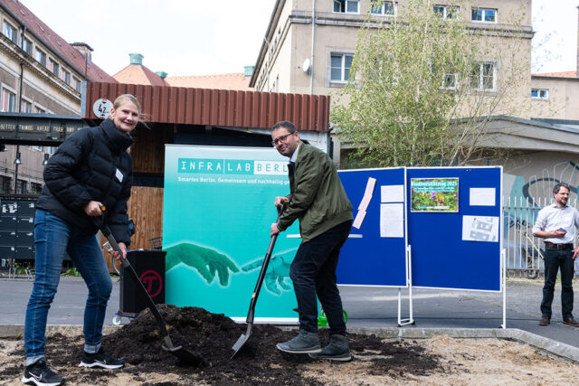 Mitarbeitende vor einem InfraLab-Effizienz-Stand bei einer Veranstaltung